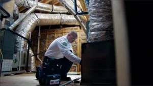 Zoomed out image of One Hour AC Tech, John, working in the attic of a Niceville FL home