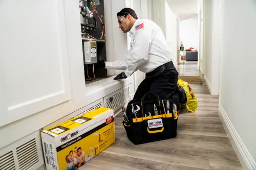 HVAC tech repairing furnace