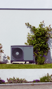 Heat pump outside modern home that embraces new heater technologies