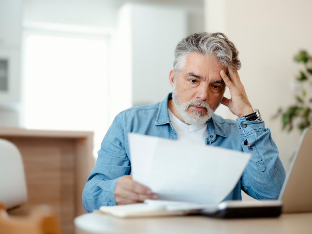 Unhappy homeowner looking at high costs on energy bill