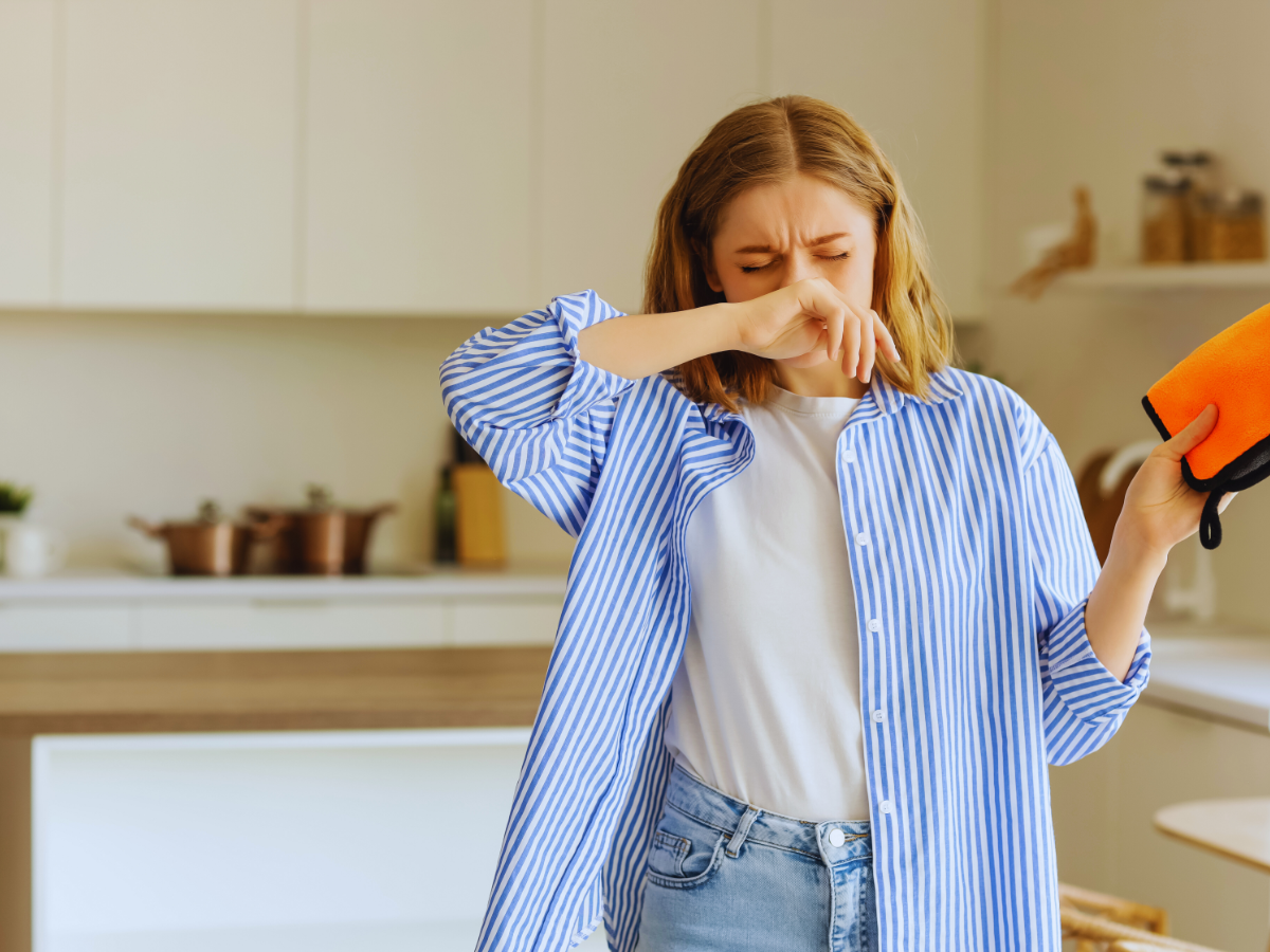 Woman sneezing because of poor indoor air quality